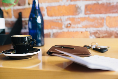 Coffee and papers on a tabletop