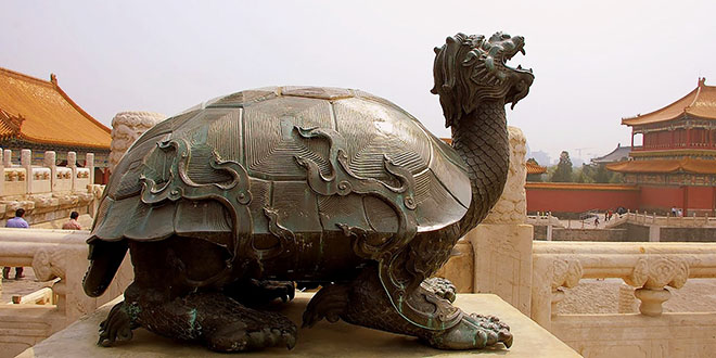 Forbidden City, Beijing: The bronze tortoise is a symbol of everlasting rule and longevity, the crane a symbol of longevity, while each sculpture on the curved roofline represents a variety of special meanings.
